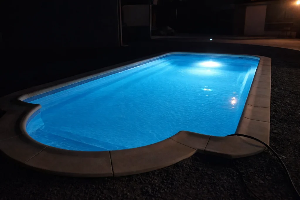 GFK-Pool mit blauer LED-Beleuchtung bei Nacht
